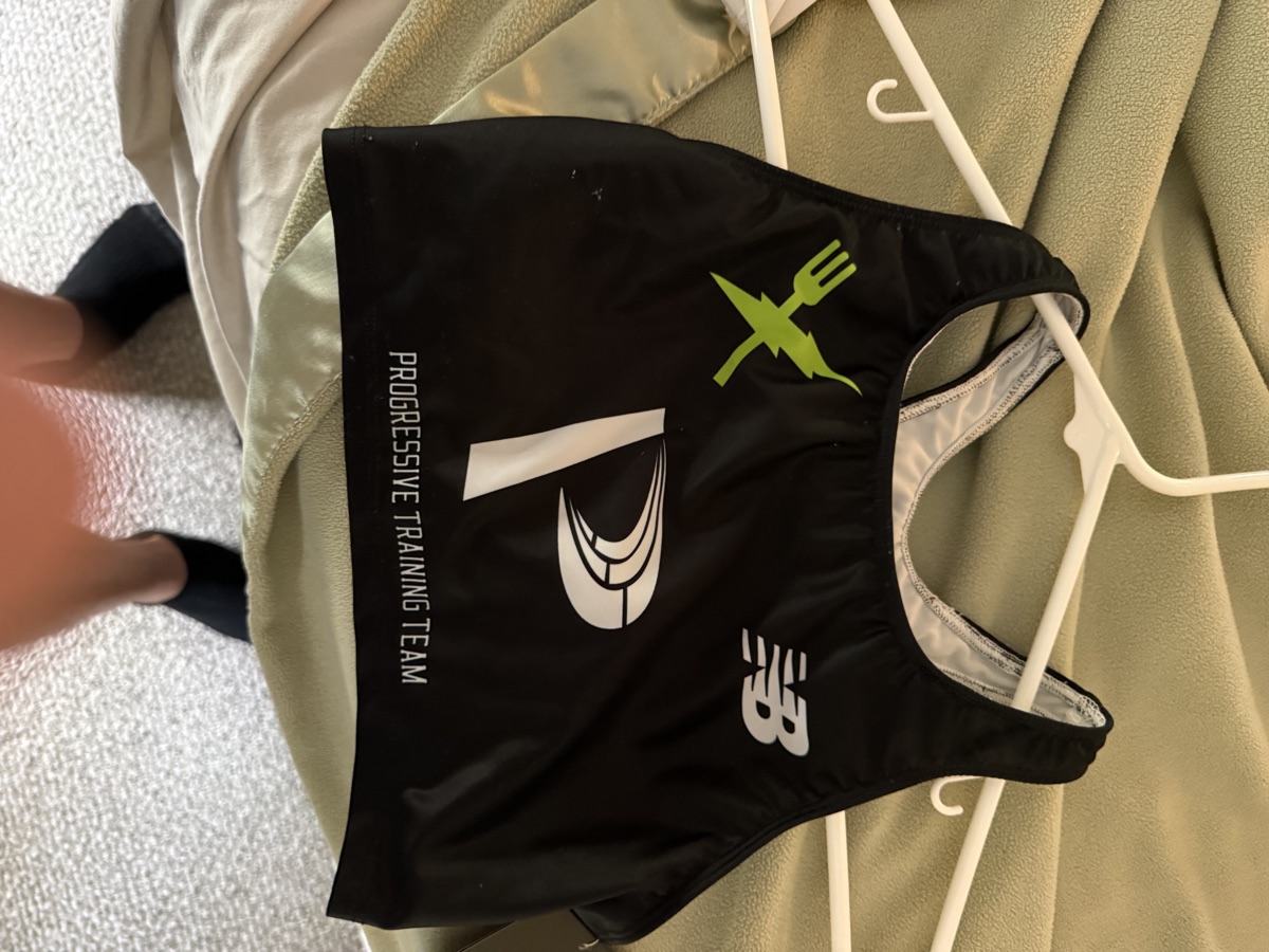 Progressive Training Team black race briefs — back view with Progressive, New Balance, and Fitlife Foods logos