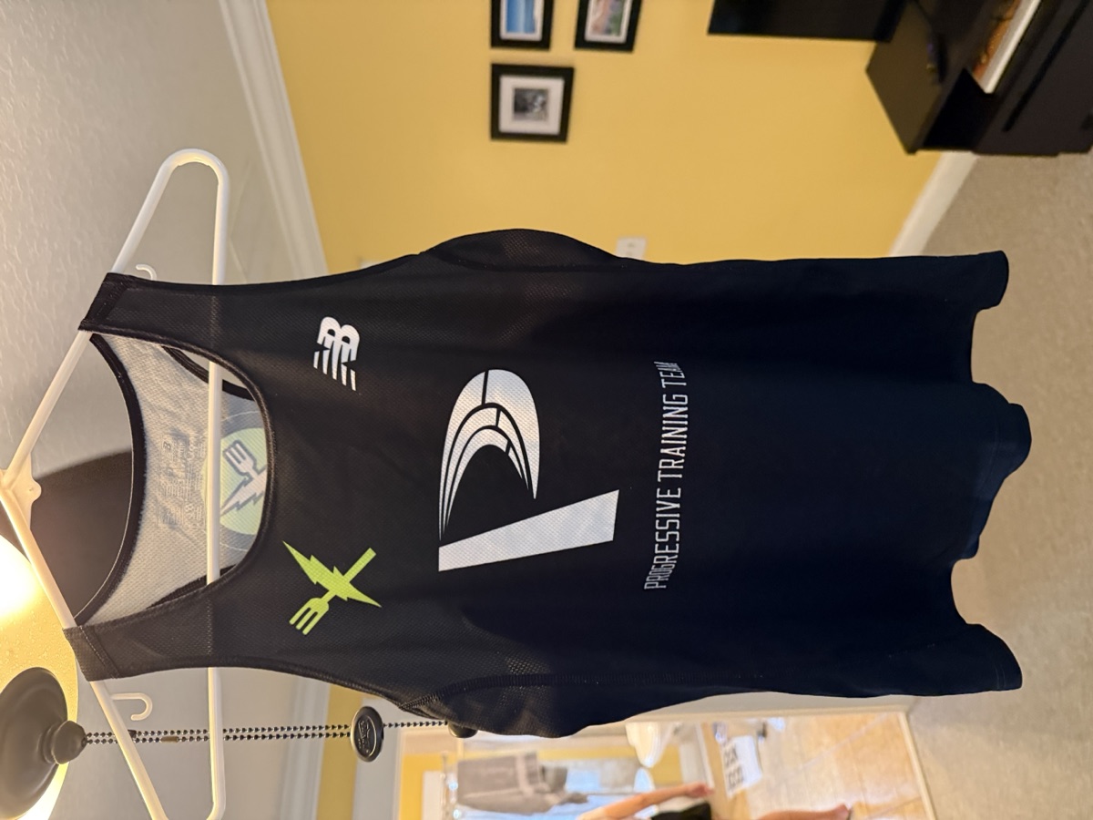 Progressive Training Team black racing singlet — front view with New Balance and Fitlife Foods logos